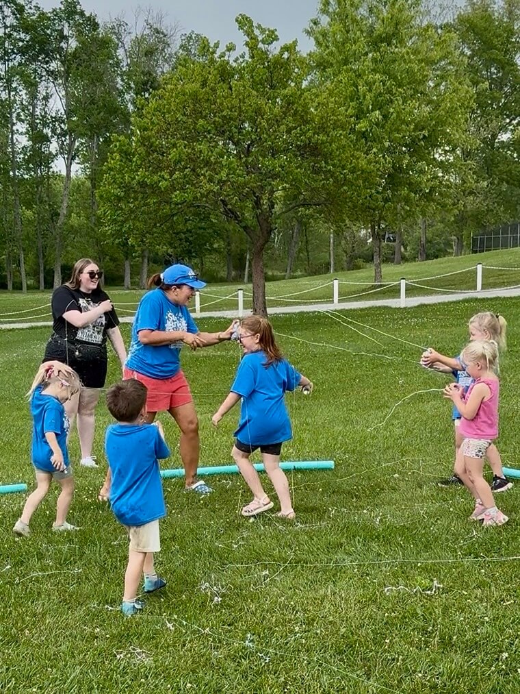 Students and teachers spraying silly string outside
